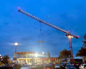 Crane over Scarborough's new development. It is dusk and the crane is lit up.
