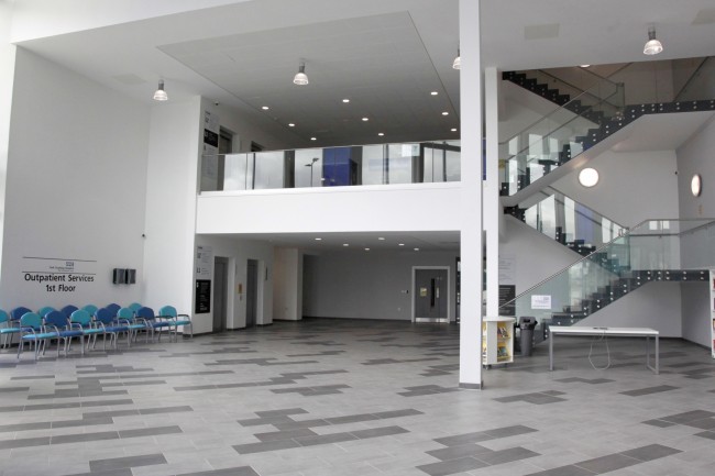 Inside the community stadium on the ground floor with stairs and lifts up to the outpatients services