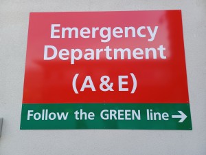 Sign instructing people to follow a green line on the floor to find the emergency department (A&E)