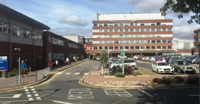 York Hospital's main entrance from a distance on a sunny day.