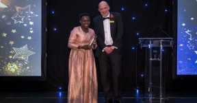 Liz onstage with the Trust's Chief Executive, Simon Morritt, to receive her award.