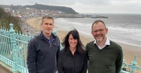 Garry Tew, Lisa Ballantine, and Phil Dickinson on a windy day at Scarborough sea front.
