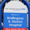 A blue and white hospital sign with white text.