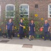 The heart failure team socially distanced stood in front of their growing sunflowers at the Clementhorpe Health Centre