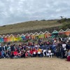 Large group of healthcare professionals on a beach in Scarborough.