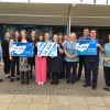 The Trust's research team standing at the front of York Hospital holding signs that say 50,000