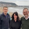 Garry Tew, Lisa Ballantine, and Phil Dickinson on a windy day at Scarborough sea front.