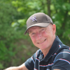 Graham Walker, a volunteer at York's ED, on a day off in the countryside. He is wearing a cap and striped polo shirt.
