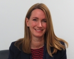 Dr Jo Mannion, with long brown hair, smiling.