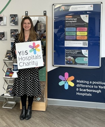 Emma Sargent holding a sign which says 