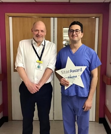 Star Award winner Pouya Alaghband receiving his award from Simon Morritt, Chief Executive.