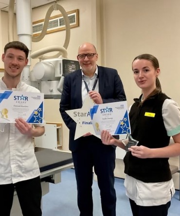 Star Award winners, Dan Burton and Faith Young, receiving their awards from Simon Morritt, Chief Executive.