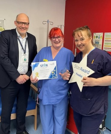 Star Award winner, Chrissy Cosheril, receiving her award from Simon Morritt, Chief Executive, and a colleague.