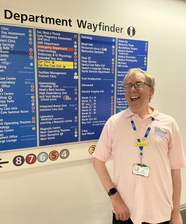 Michael in front of hospital signage.