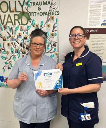 Star Award winner Kate Gordon receiving her award from a colleague.