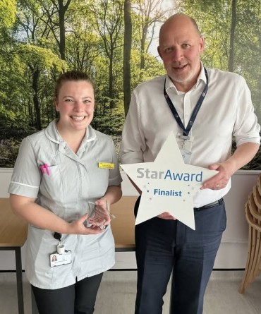 Star Award winner Lucy Hyde receiving her award from Simon Morritt, Chief Executive.