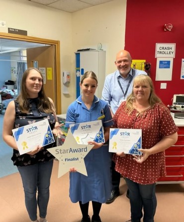 Star Award winner Kristie Braviner, Adele Bayes-Warley, and Helen Jennison receiving her award from Simon Morritt, Chief Executive.