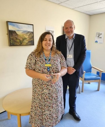 Star Award winner Michaela Quinn receiving her award from Simon Morritt, Chief Executive.