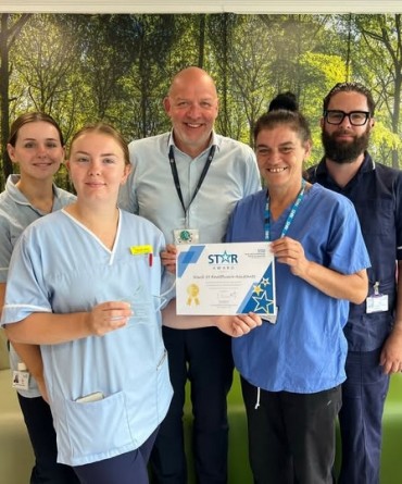 Star Award winners Ward 39 Healthcare Assistants receiving her award from Simon Morritt, Chief Executive.