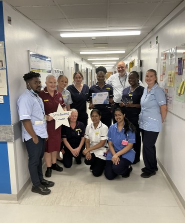 Star Award winners Acute Medical Unit receiving their award from the Trust's Chief Executive, Simon Morritt.
