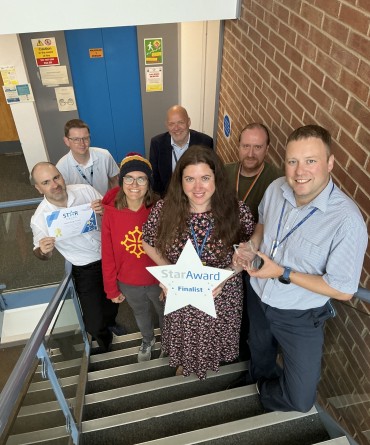 Star Award winners Reporting Team receiving their award from the Trust's Chief Executive, Simon Morritt.