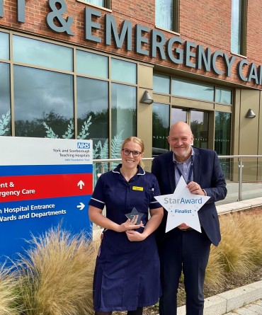 Star Award winner Hannah Jones receiving her award from the Trust's Chief Executive, Simon Morritt.