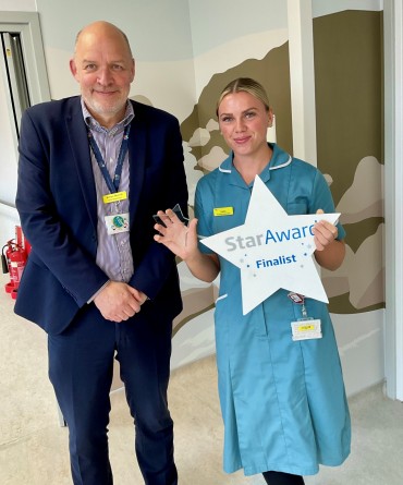 Star Award winner Harriet Gibson receiving her award from the Trust's Chief Executive, Simon Morritt.