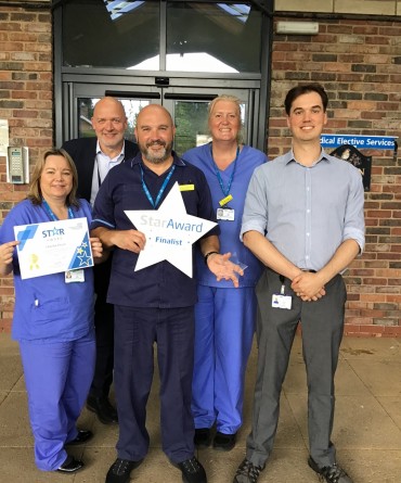 Star Award winner Charlie Bryce with colleagues, receiving his award from the Trust's Chief Executive, Simon Morritt.