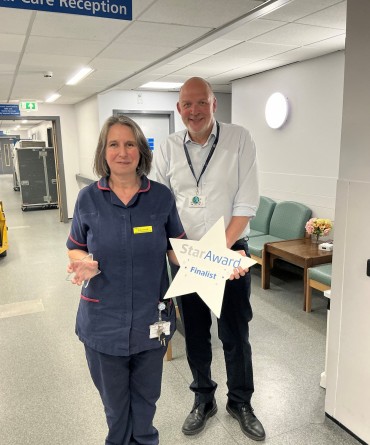 Star Award winner Clare Scott receiving her award from the Trust's Chief Executive, Simon Morritt.