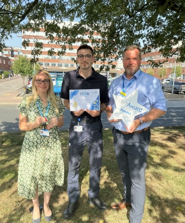 Star Award winner Daniel Robinson, with a colleague, receiving his award from Chris Norman, Head of YTHFM.