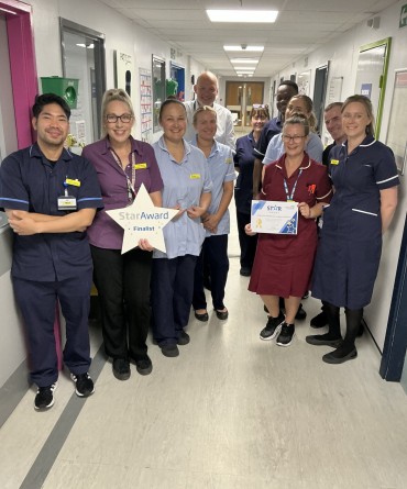 Star Award winners Ward 34 healthcare support workers and wider team receiving their award from the Trust's Chief Executive, Simon Morritt.