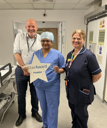 Star Award winner Subashini Vasudevan receiving her award from a colleague and Simon Morritt, the Trust's Chief Executive.