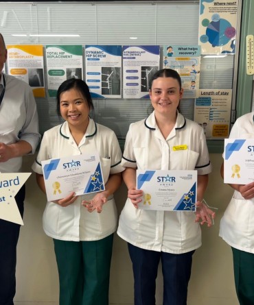 Star Award winners Beam Kleaklom-Wilson, Emma Myers, and Sophie Goodfellow receiving their award from the Trust's Chief Executive, Simon Morritt.