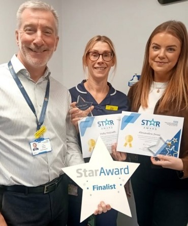 Star Award winners Vicky McGrath and Alex Jones receiving their award from Andrew Bertram, Interim Chief Executive.