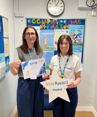 Star Award winner Helen Howell receiving her award from Chief Executive, Clare Smith. Helen is wearing a polo short with 