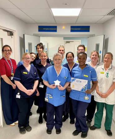 Star Award winners, the Emergency Department, receiving their award from Clare Smith, Chief Executive.