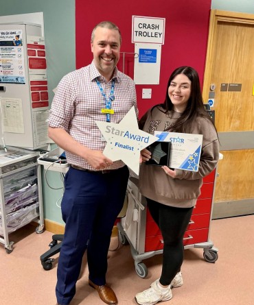 Star Award winner Abigail McCulloch receiving her award from Chief Nurse, Joe Hague.