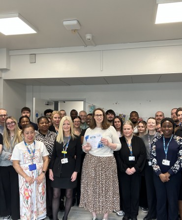 Star Award winner Kate Aplin receiving her award from Clare Smith, Chief Executive, and a large group of colleagues from the labs