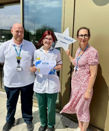 Star Award winner Lucy Wood receiving her award from Clare Smith, Chief Executive, and her nominator, David Burton.