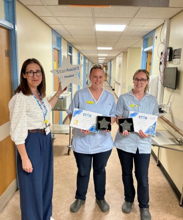 Star Award winners Rhea Trower and Clare Ladle receiving their award from Clare Smith, Chief Executive.