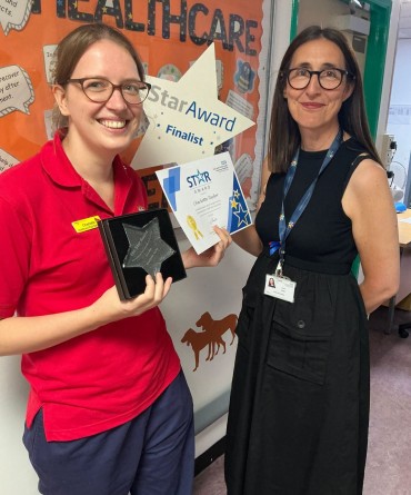 Star Award winner Charlotte Taylor receiving her award from Clare Smith, Chief Executive.