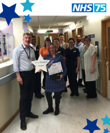 Claire Mckee and her Team receiving their Star Award from Andrew Bertram.