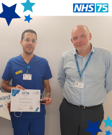 Yassin Ahmed receiving his Star Award from Chief Executive, Simon Morritt