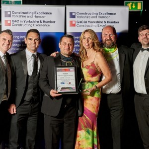 A group of people posing for a photo with an award.