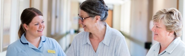 Banner image featuring two members of staff alongside a patient.
