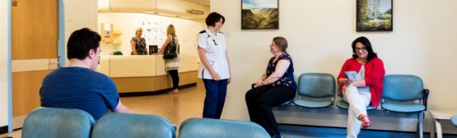 Banner image featuring patients and staff around a hospital waiting room.