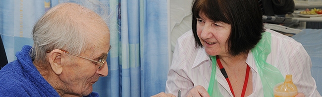 A patients being cared for by a member of staff