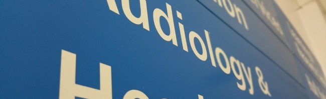 Internal blue hospital signage with the text 'Audiology' on