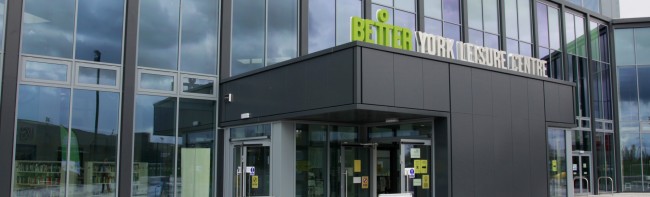 The York Community Stadium main entrance from outside with signage for 'Better York Leisure Centre'