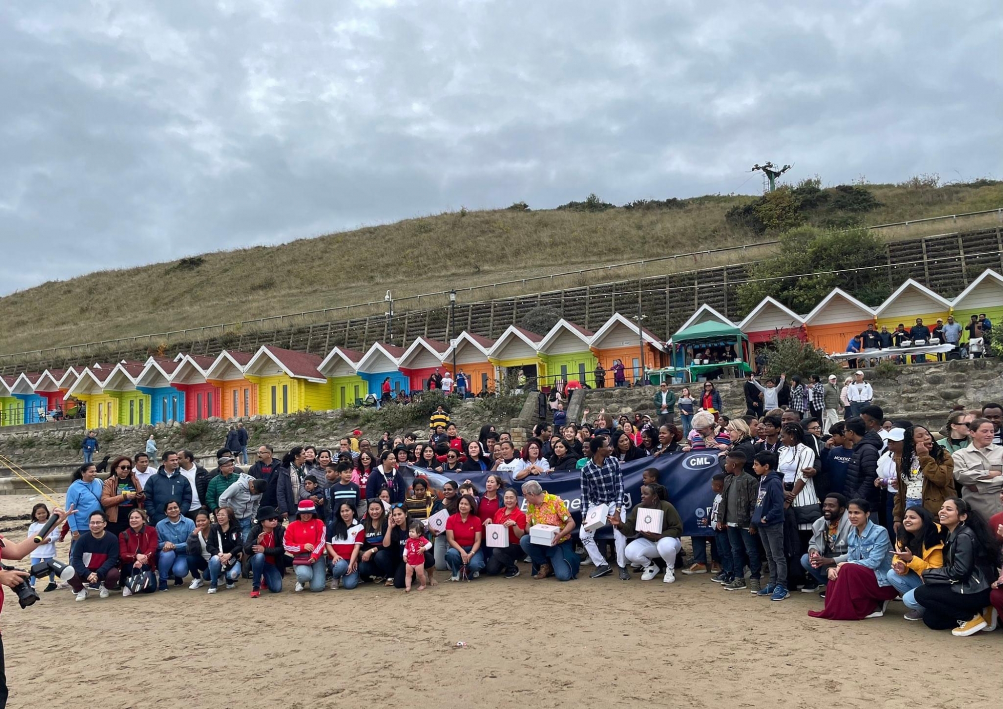 Large group of healthcare professionals on a beach in Scarborough.